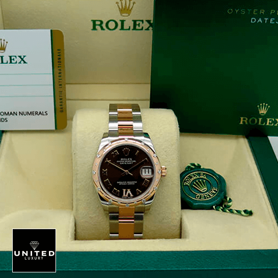 Rolex Datejust178341 Chocolate Roman Replica warranty card in the box next to it