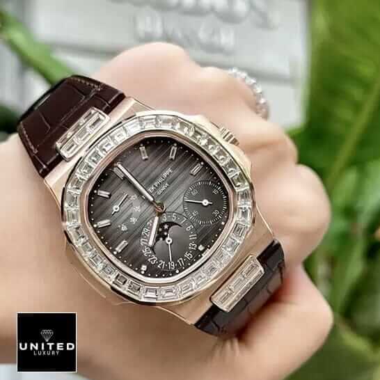 Patek Philippe Nautilus 5724 "Baguette Diamonds" 1:1 Clone Edition patek philippe baguette replica 4 Patek Philippe Gold Case Diamond Bezel Black Dial Replica on thhe hand